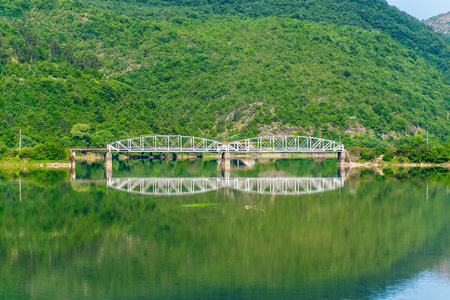 The railway bridge passes over a mountain river.の写真素材