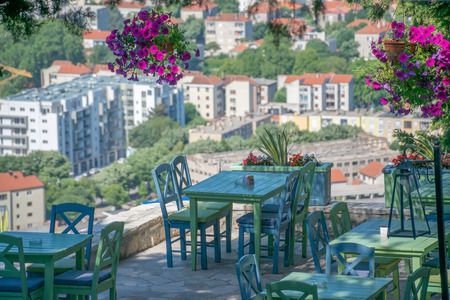 Cozy panoramic tables in a cafe on the terrace over an ancient city.の写真素材