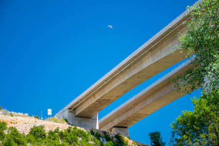 Through the Kravice National Park in Bosnia and Herzegovina there is a long modern bridge.
