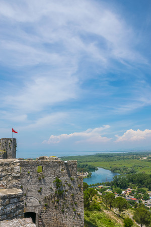 Albanian red flag with a black double-headed eagle towers above the fortress of Rozafa.の写真素材