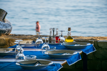 Evening tables near the sea during sunsetの写真素材