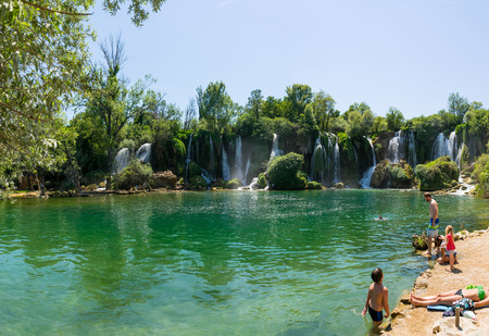BOSNIA AND HERZEGOVINA, LYUBUSHKI - JUNE 01/2017: tourists rest and swim in the picturesque waterfall.のeditorial素材