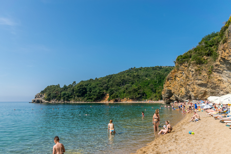 MONTENEGRO, BUDVA - JUNE 05/2017: tourists swim on the Mogren beach in the hot season.のeditorial素材