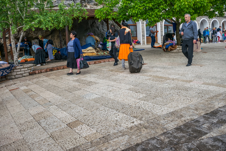 MONTENEGRO, OSTROG MONASTERY - JUNE 03/2017: The pilgrims came to a medieval monastery for the celebration of the Holy Trinity.のeditorial素材