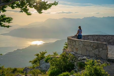 Cute young girl admiring the scenery from the viewpoint.の写真素材