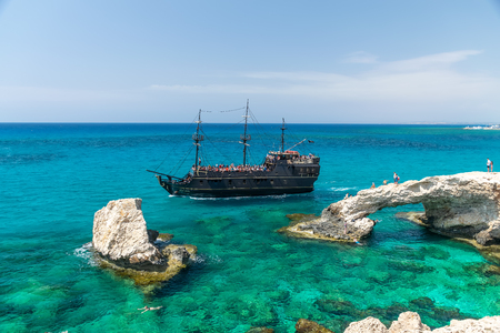 CYPRUS, AYIA NAPA - MAY 11/2018: tourists float on the ship near the most popular attraction - the Bridge of Love.のeditorial素材