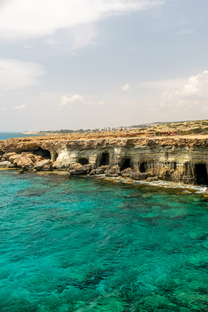 CYPRUS, AYA NAPA - MAY 11, 2008: Tourists stroll along the coast near the picturesque sea caves.のeditorial素材