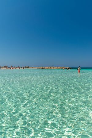 CYPRUS, NISSI BEACH - MAY 12/2018: Tourists relax and swim on one of the most popular beaches on the island.のeditorial素材
