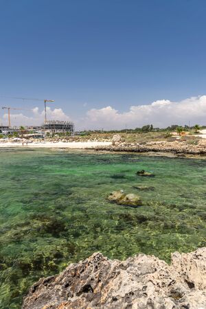 Tourists relax on the beautiful Ayia Thekla Beachの写真素材