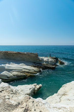 Fishermen are fishing on the seashore. coast of white stones.の写真素材