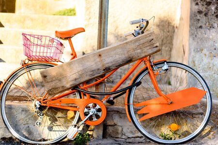 orange ride bike with wooden signの写真素材