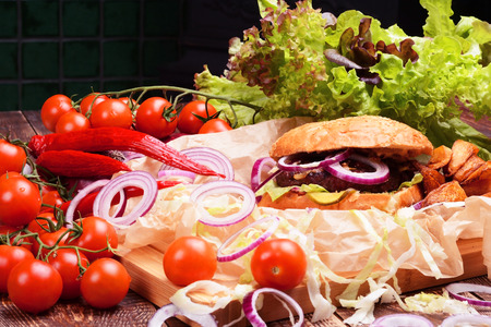 Delicious homemade burger with fresh vegetables and beef.の写真素材