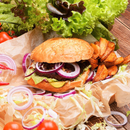 Delicious homemade burger with fresh vegetables and beef.の写真素材