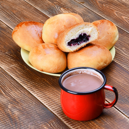 Several yeast rolls with jam and a cup of cocoa.の写真素材