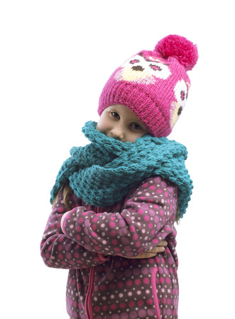 Portrait of a girl in a cap and scarf . Isolated background.の写真素材