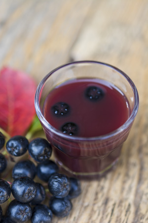 A glass of tincture of chokeberry.の写真素材