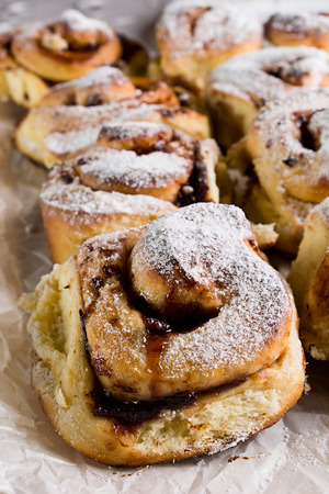 Homemade fresh baked yeast buns with plum jam. Sprinkled with icing sugar.の写真素材