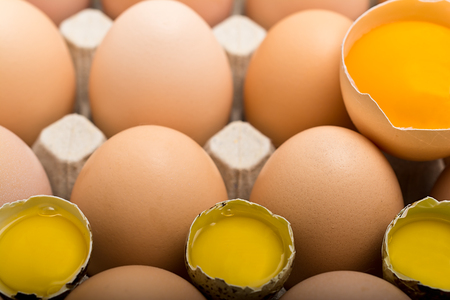 Background of chicken and quail eggs in a cardboard tray.の写真素材