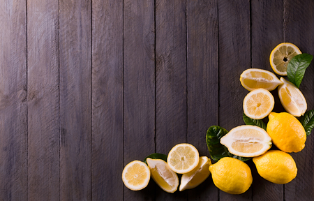 Fresh lemons on rustic wooden background.の写真素材
