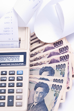 Japanese Yen banknote money with calculator.の写真素材