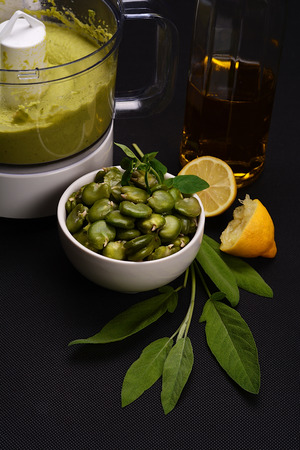 Bean paste and boiled broad beans on a black background.の写真素材