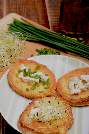 French toasts with goats cheese, fresh chives and sprouts.の写真素材
