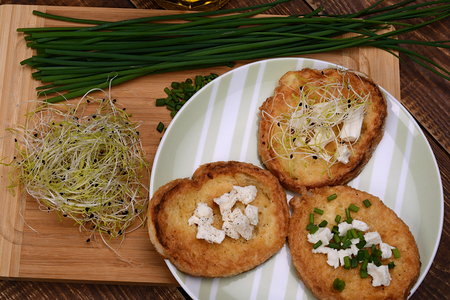 French toasts with goats cheese, fresh chives and sprouts.の写真素材