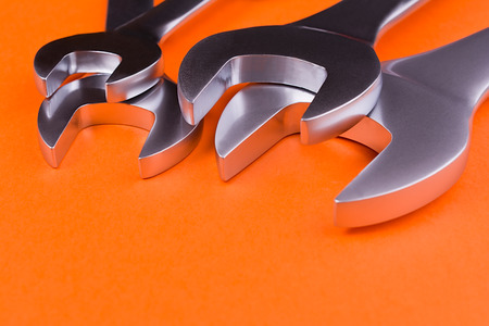 Spanners of various sizes, on orange backgroundの写真素材