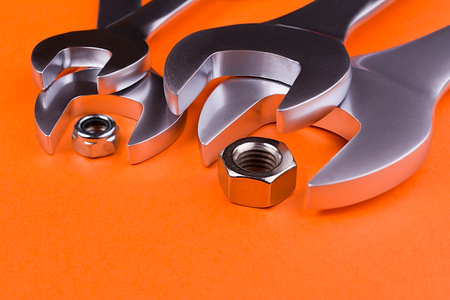 Spanners of various sizes, on orange backgroundの写真素材