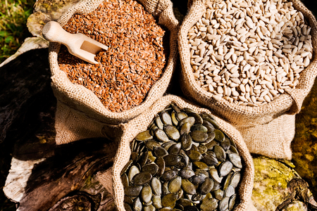 Pumpkin seeds, sunflower and flax seeds in  jute bag.の写真素材