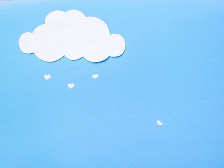 Paper clouds from which the paper hearts fall.の写真素材