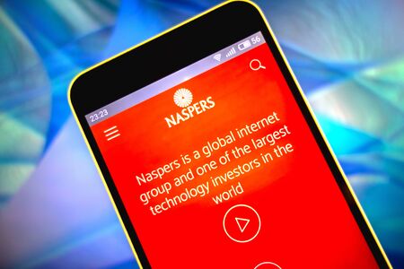 Berdyansk, Ukraine - March 19, 2019: Naspers website homepage. Naspers logo visible on the phone screen.のeditorial素材