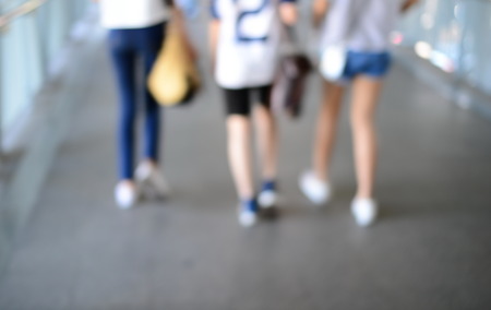 blur walking legs of three young womanの写真素材