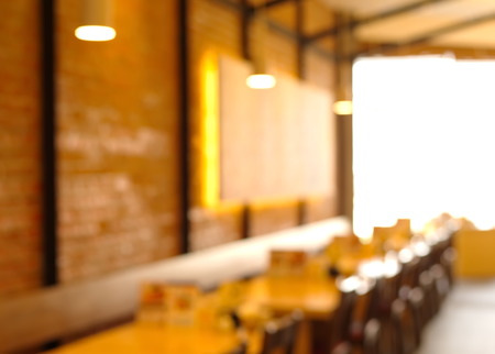 blur interior row wood table and chair restaurant
