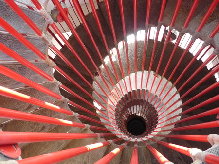 metal and concrete red spiral stairの写真素材