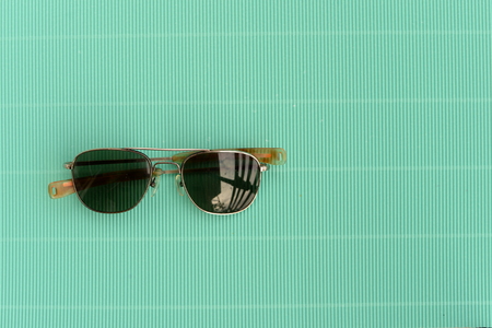 retro sunglasses on green vintage backgroundの写真素材