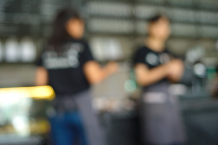 blur two waitress in black T-shirt at coffee barの写真素材