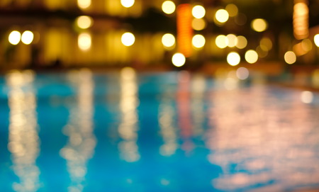 blur night light reflection in blue waving waterの写真素材