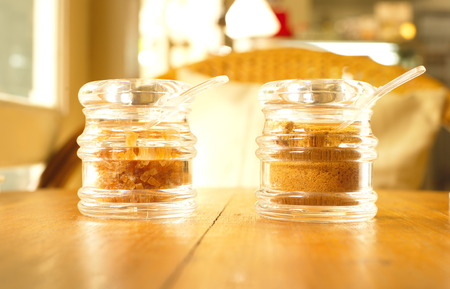 organic brown sugar in clear jar on wood tableの写真素材