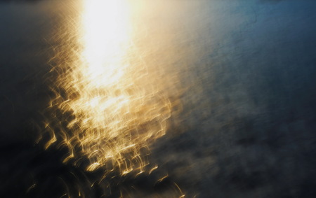 light of water movement in the sea at sunsetの写真素材