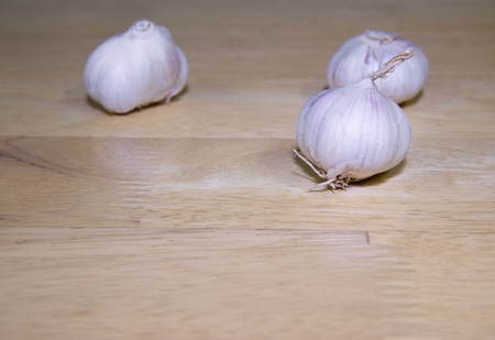white garlic on wood backgroundの写真素材