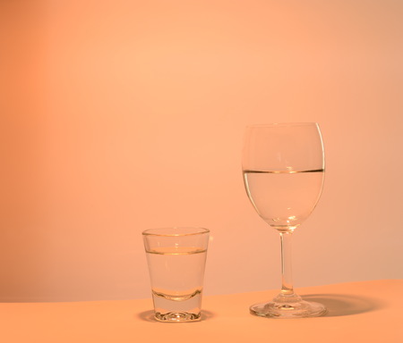wine and shot glass  orange lightの写真素材