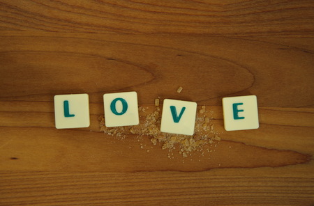 love puzzle letter with brown sugar on wood backgroundの写真素材