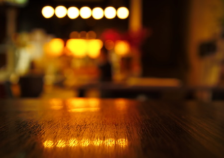 blur light reflection on table in bar at night background