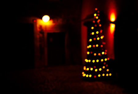 blur bokeh orange light Christmas in dark night backgroundの写真素材