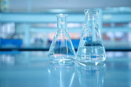 glass flask in blue science lab background