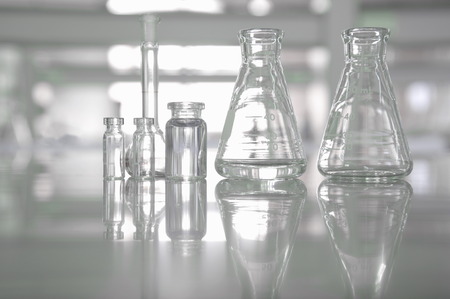 clear glassware flask vial in white science laboratory backgroundの写真素材