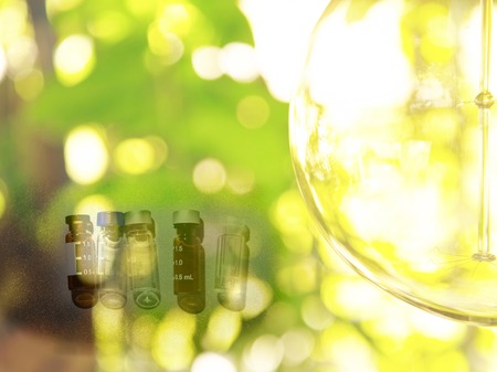 brown and clear vials for science lab with green natural and round glass  backgroundの写真素材