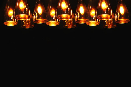 row of orange  light lamp on black background