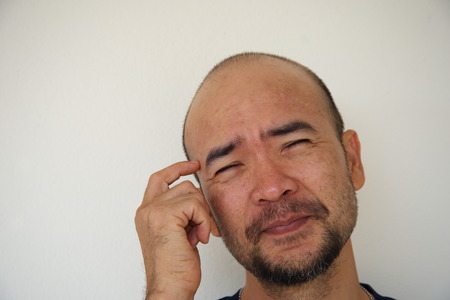portrait of japanese bald beard man funny thinking action on white background